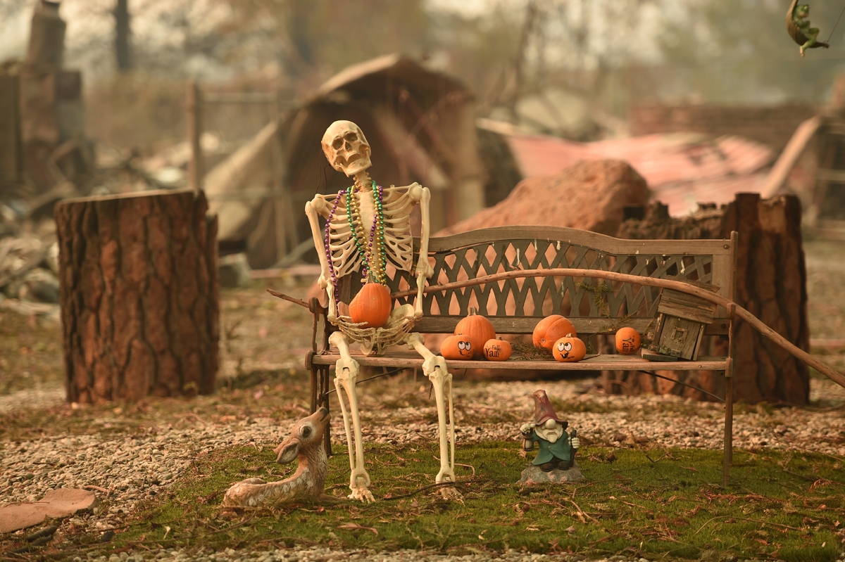 A halloween decoration remains at a burned home after the Camp fire tore through the region in Paradise, California on November 12, 2018.