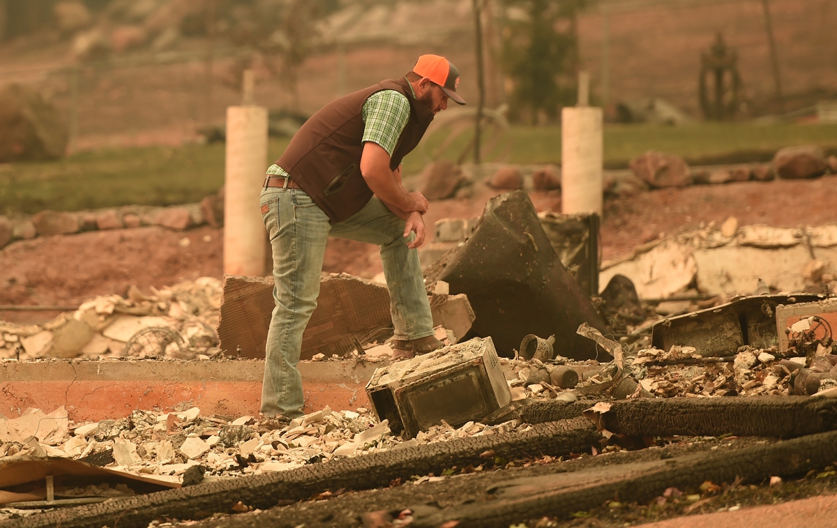 Chris Brown looks over the remains of his burned home in Paradise, California on November 12, 2018.