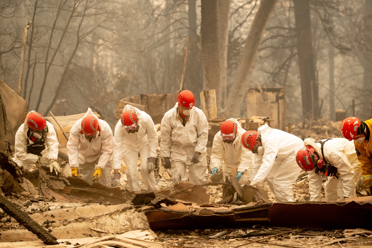 Rescue workers sift through rubble in search of human remains at a burned property in Paradise, California on November 14, 2018.