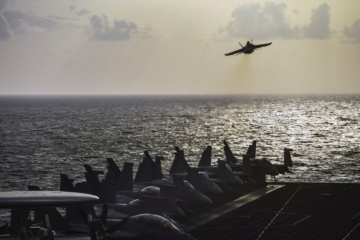 An F18 fighting jet takes off from the 330 meters aircraft carrier Harry S Truman works inside a transport airplane on eastern Mediterranean Sea on May 8, 2018.