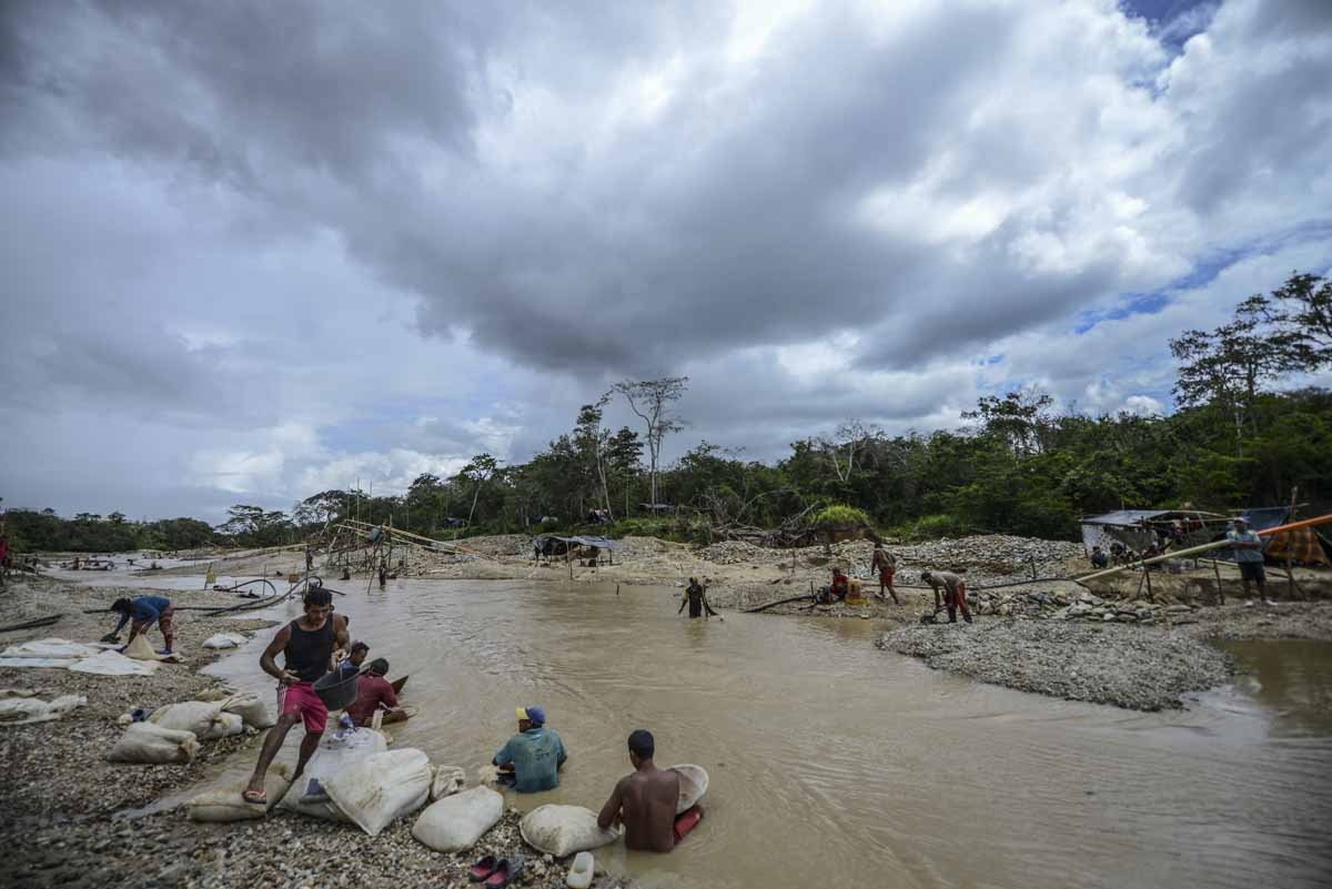 Men work at Nacupay gold mine on the banks of a river in El Callao, Bolivar state, southeastern Venezuela on February 24, 2017. Although life in the mines of eastern Venezuela is hard and dangerous, tens of thousands from all over the country head for the