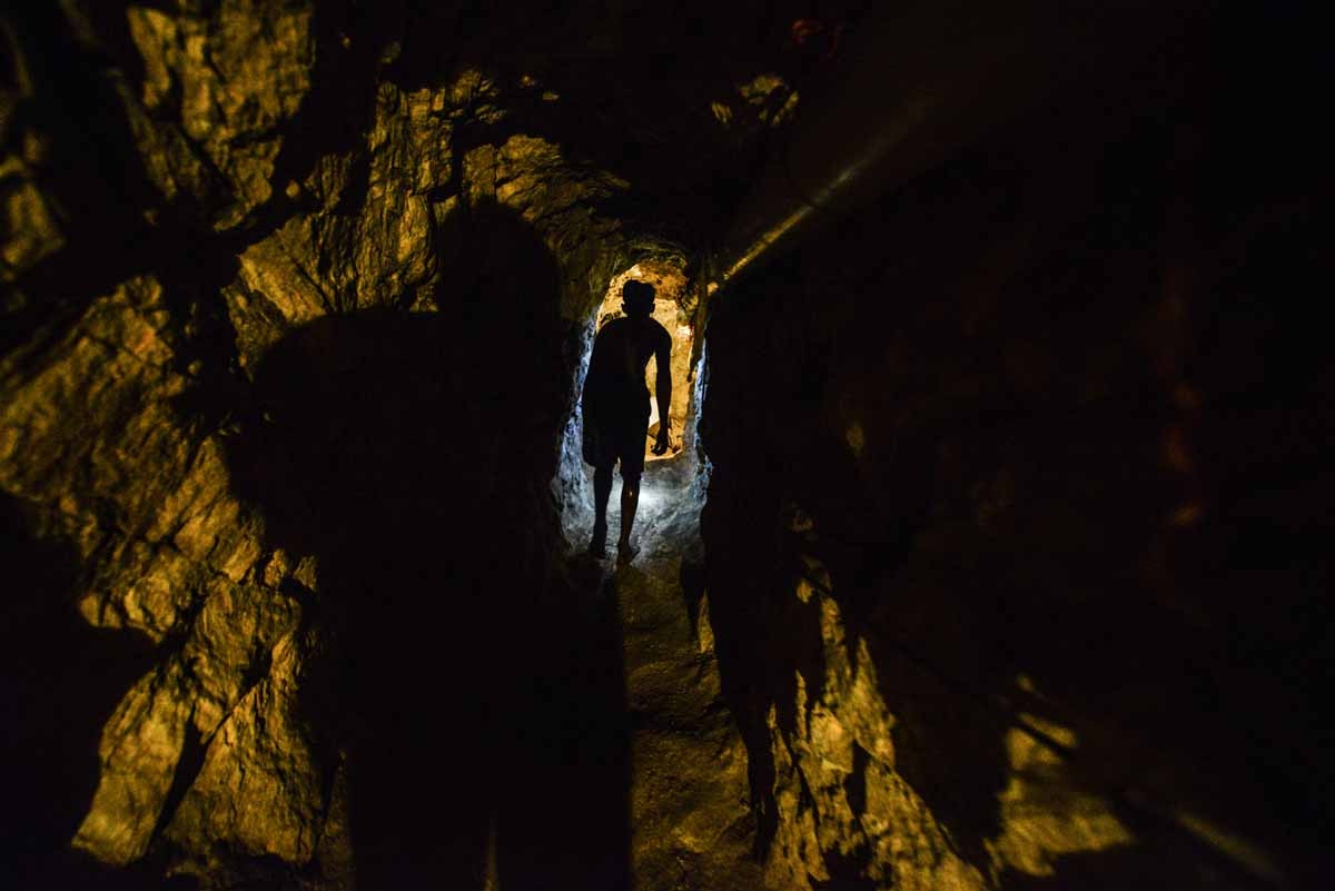 A man walks in a tunnel at a gold mine in El Callao, Bolivar state, southeastern Venezuela on March 1, 2017. Although life in the mines of eastern Venezuela is hard and dangerous, tens of thousands from all over the country head for the mines daily in ove