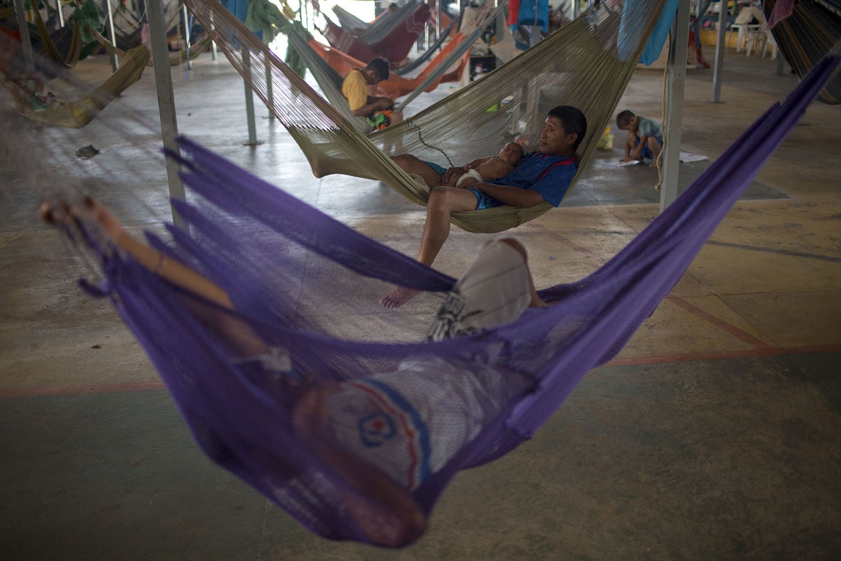 Venezuelan indigenous refugees rest on their hammocks, at the Pintolandia shelter in the city of Boa Vista, Roraima, Brazil, on February 24, 2018. When the Venezuelan migratory flow exploded in 2017 the city of Boa Vista, the capital of Roraima, 200 kilom
