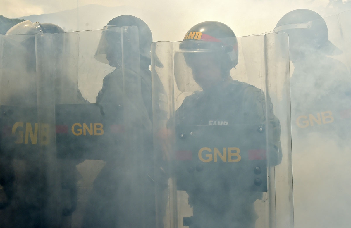 Members of the National Guard crack down on opposition demonstrators during a march against President Nicolas Maduro, in Caracas on April 26, 2017. Venezuelan riot police fired tear gas to stop anti-government protesters from marching on central Caracas,