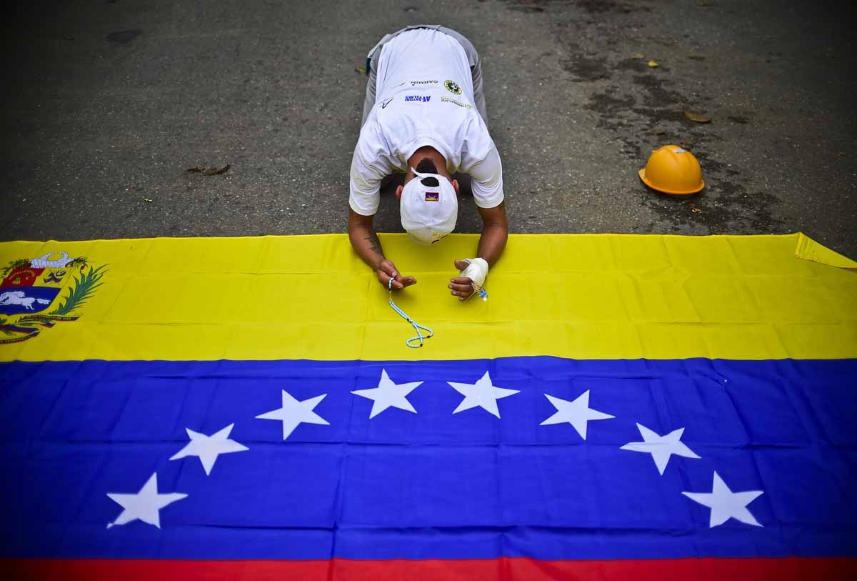 Venezuelan opposition activists attend a march against President Nicolas Maduro, in Caracas on May 1, 2017. May Day protests risk being rough in Venezuela as it marks one month since deadly clashes erupted in a political crisis with no end in sight. Prot