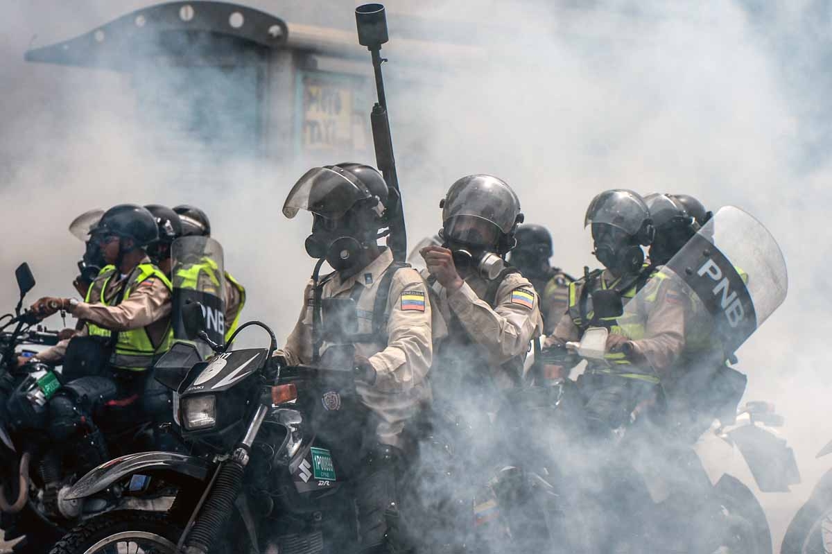 Riot police ride their motorcylces as clashes erupt during a protest against President Nicolas Maduro, in Caracas on May 8, 2017. Venezuela's opposition mobilized Monday in fresh street protests against President Nicolas Maduro's efforts to reform the con