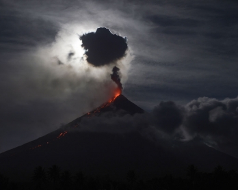  The 'super blue blood moon' obscured by clouds illuminates Mayon volcano as it spews ash near Legazpi City, Albay province, early on February 1, 2018.